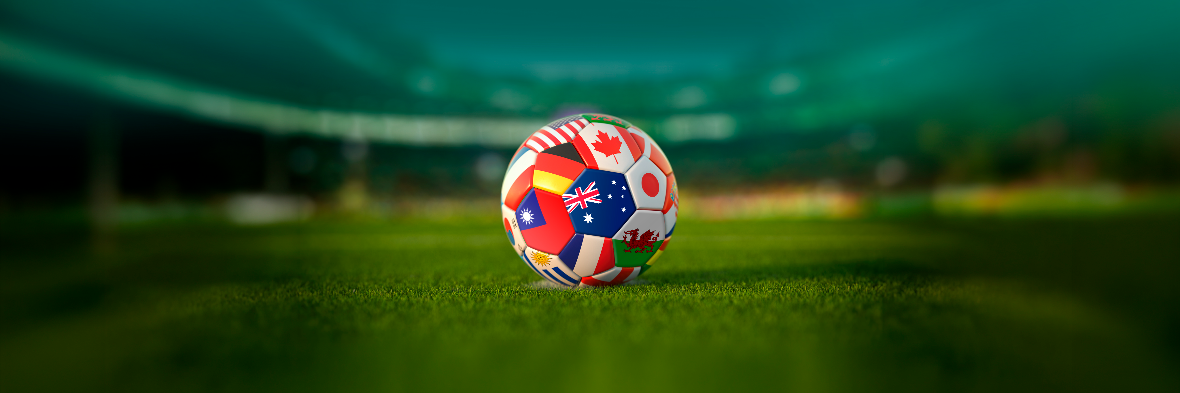 Flag-painted football resting on the Redlands FC pitch